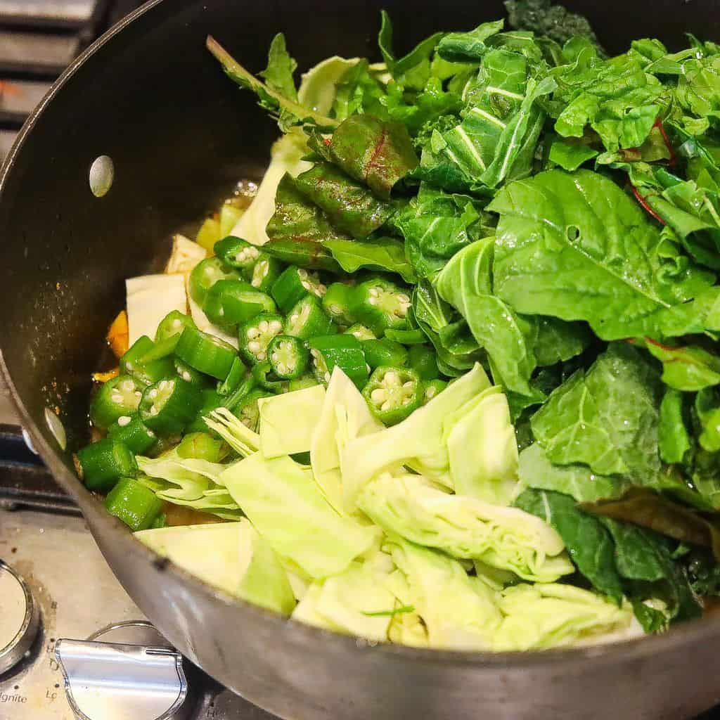 greens, cabbage, okra in large pot cooking