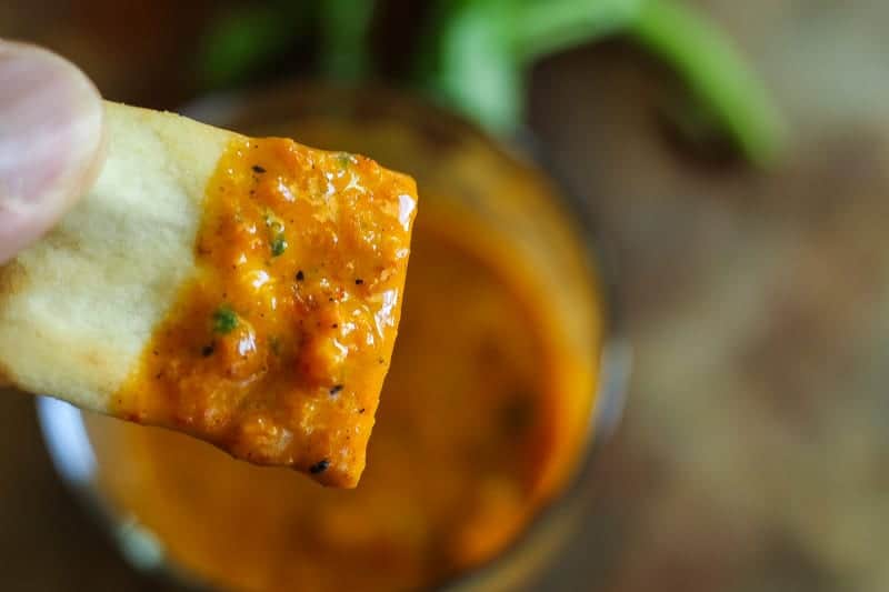 jar of roasted red pepper sauce with basil and garlic on a cutting board #redpepper #sauce www.foodfidelity.com