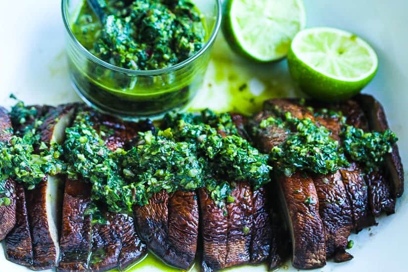 grilled portobello mushrooms on a plate with spinach chimichurri #mushrooms #portobellos www.foodfidelity.com