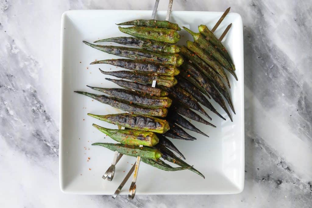 grilled okra on a white plate