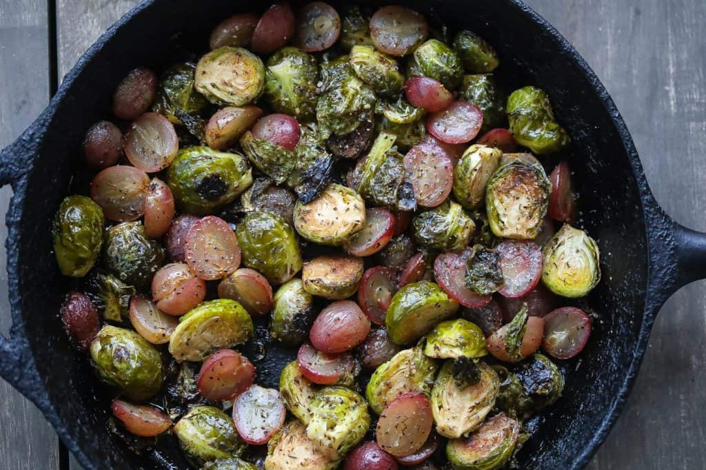 roasted brussel sprouts and grapes in a skillet