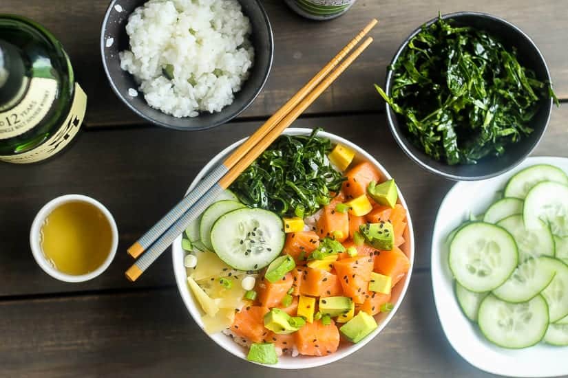 salmon poke bowl with cucumbrs, collard green salad, avocado, pickled beets and ginger