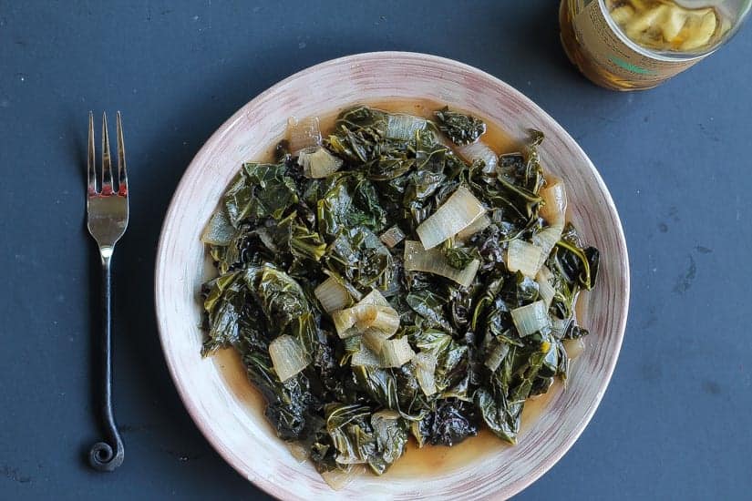 wine braised collard greens on a plate