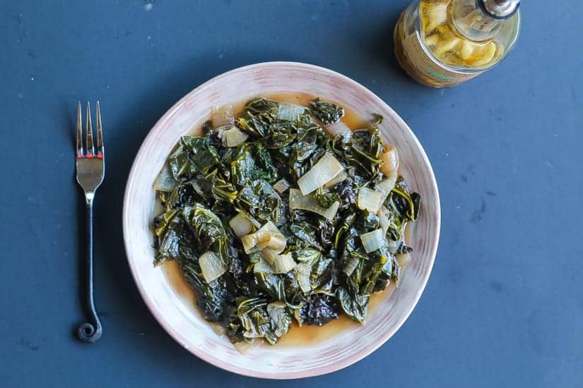 wine braised collard greens on a plate
