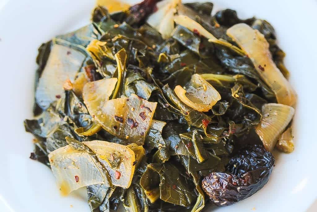 meatless wine braised collard greens with onions in a bowl