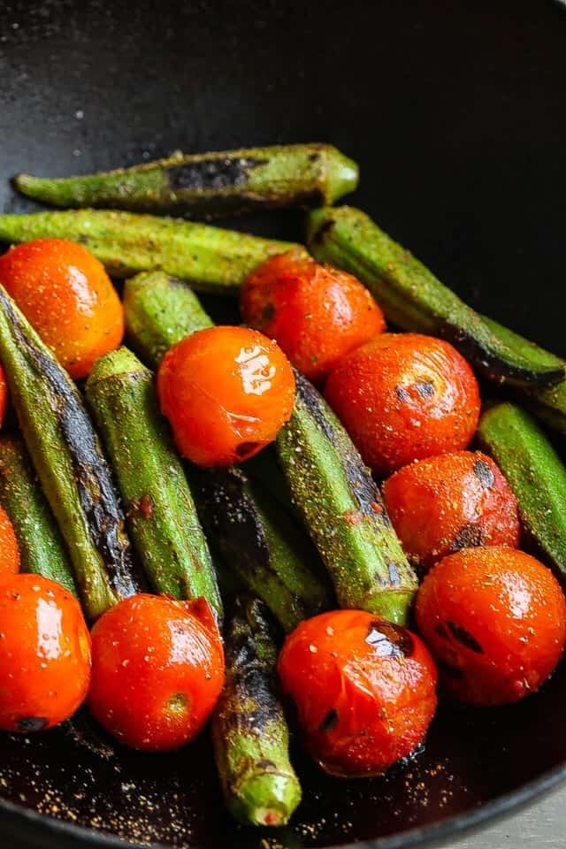 okra and tomatoes cooking in skillet
