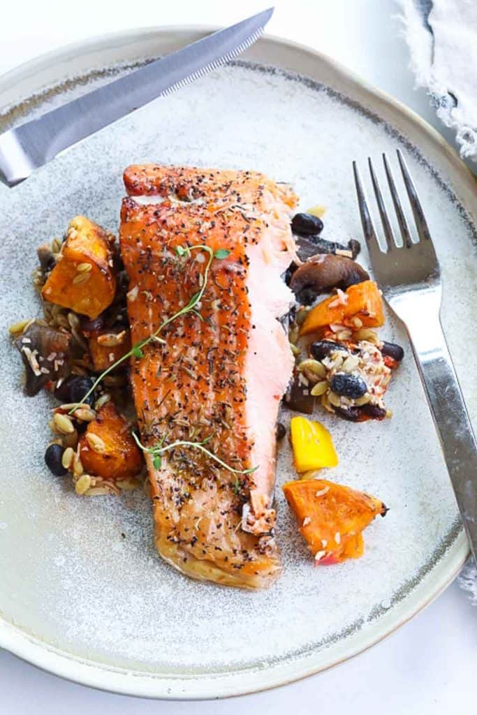 smoked trout on a plate with vegetables