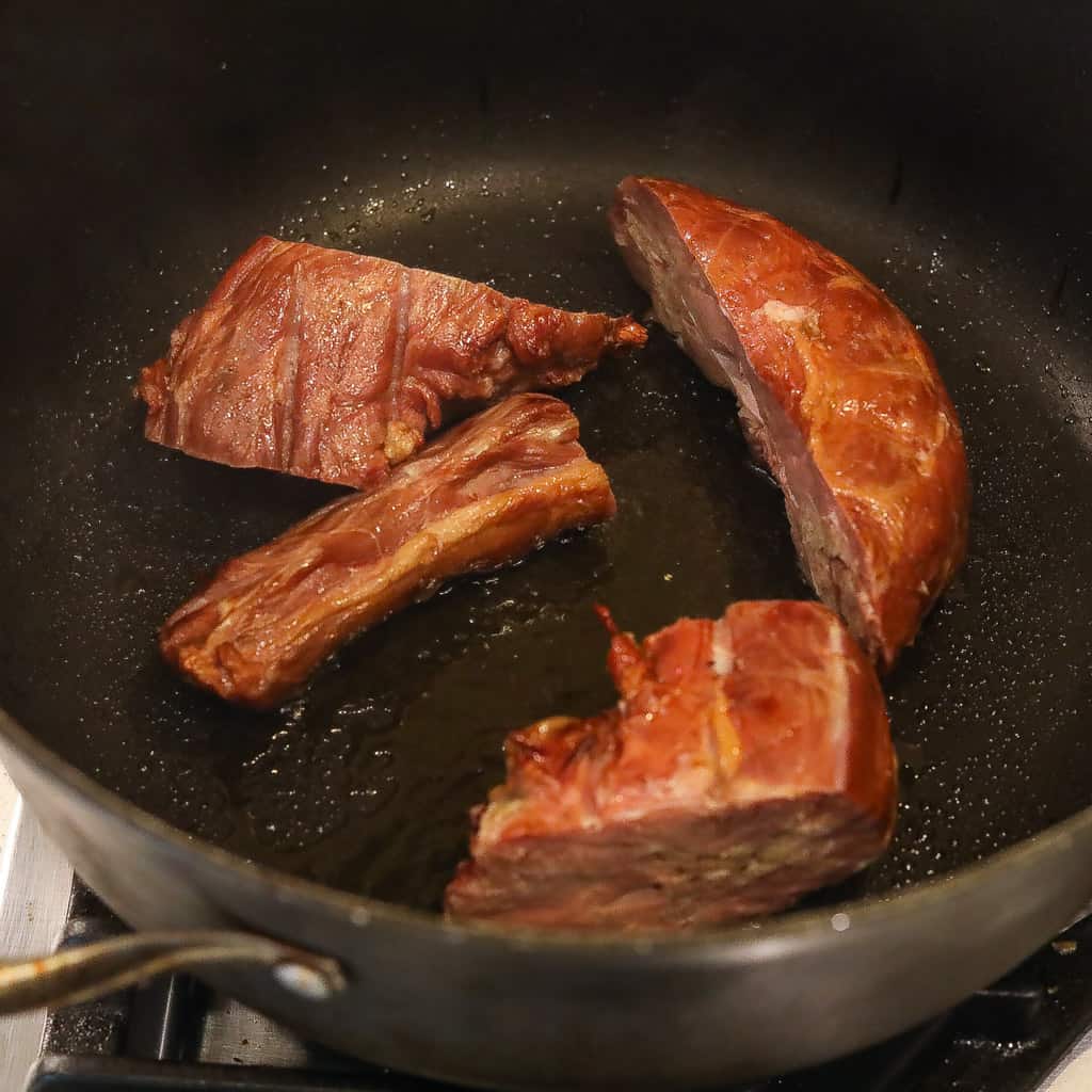 turkey necks browning in pan