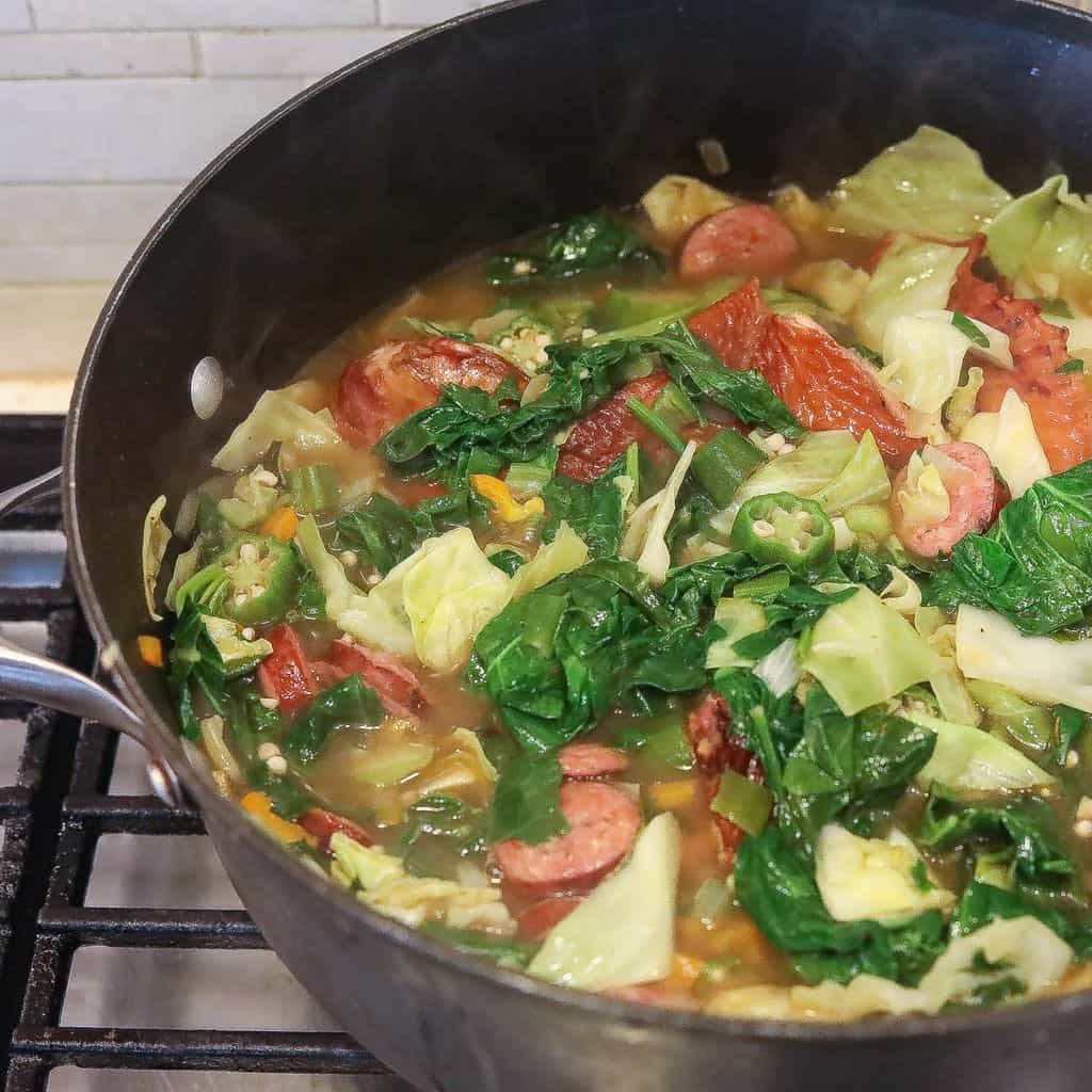 gumbo z'herbes with greens and cabbage cooking in pot