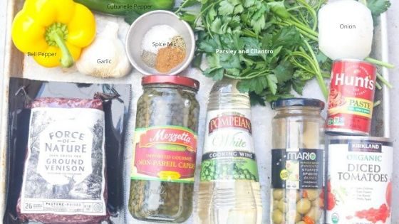 ingredients for picadillo on a silver tray