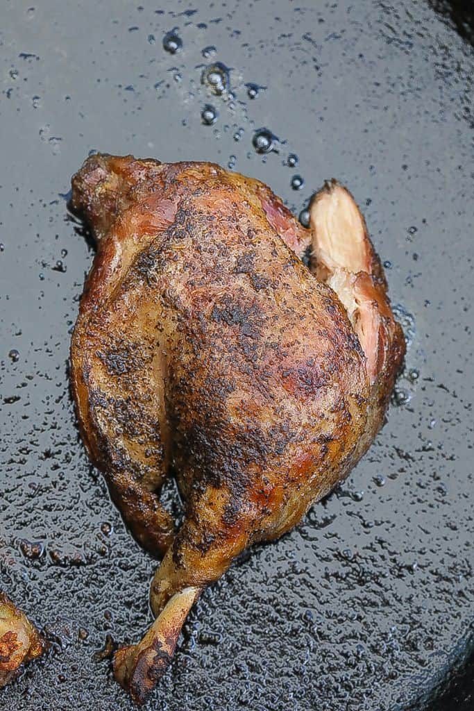 duck confit in skillet cooking