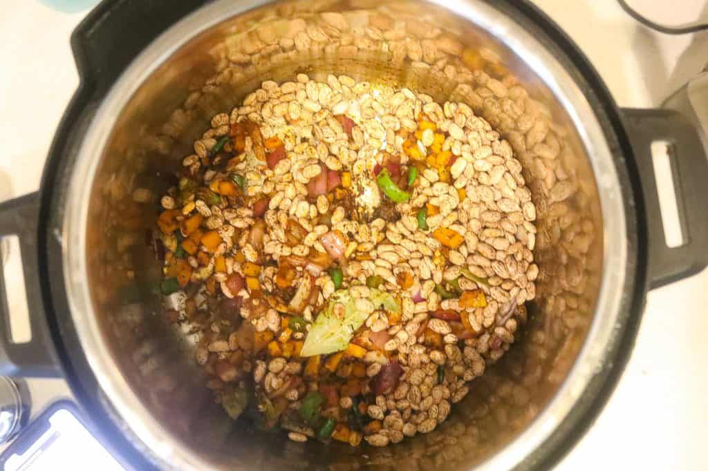 beans and peppers cooking in a pot