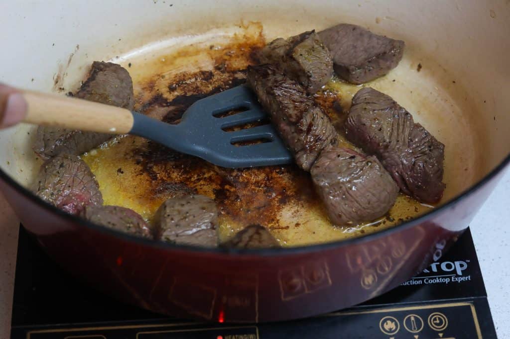 spatula removing beef from pot