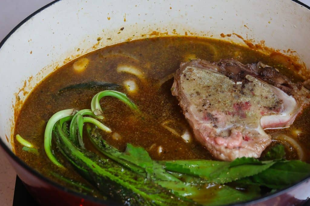 beef and culantro boiling in broth