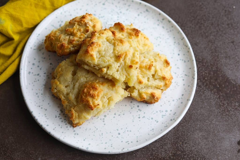 buttermilk biscuits stacked on a white plate