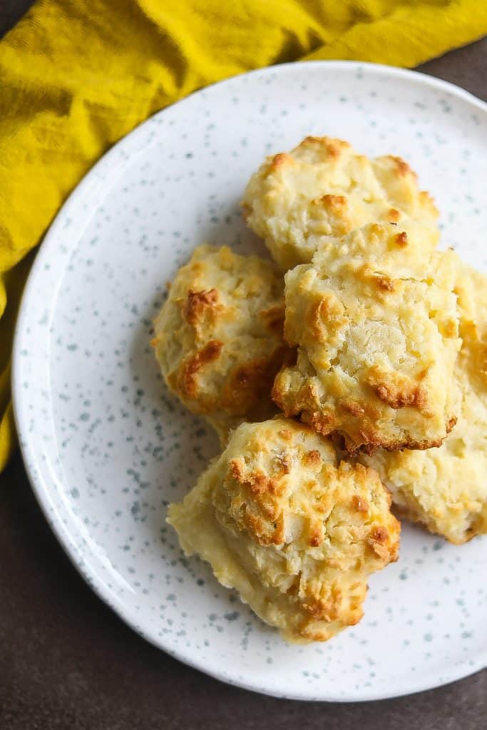 buttermilk biscuits stacked on a white plate