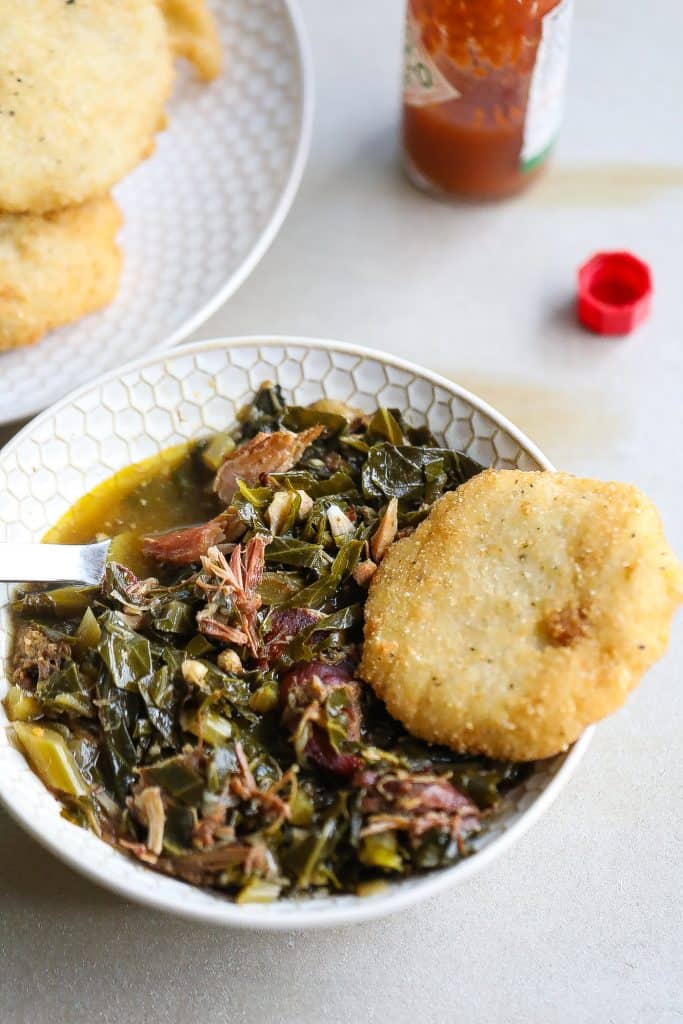 collard greens and cornbread in a white bowl