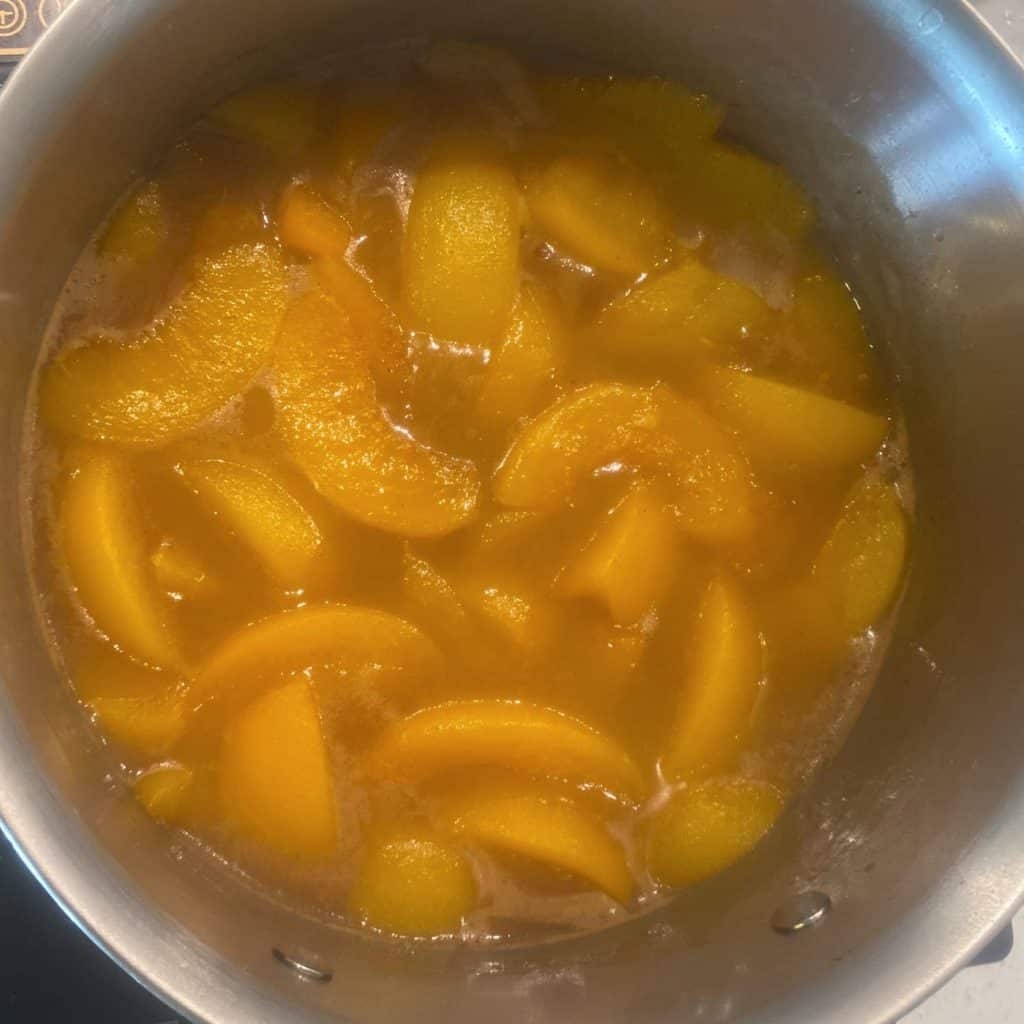 peach cobbler filling in a pot