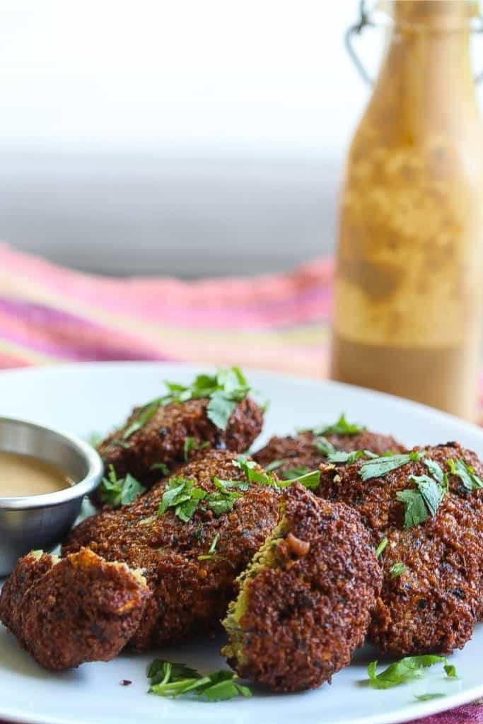 blackeyed pea falafels on a white plate topped with parsley