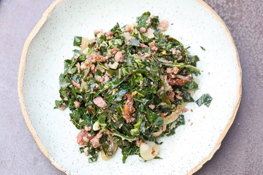 brazilian collard greens and turkey pices on a green plate