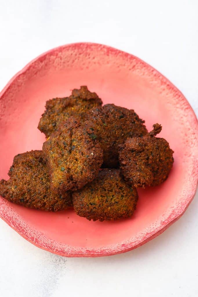 blackeyed pea falafel on a plate with tahini sauce