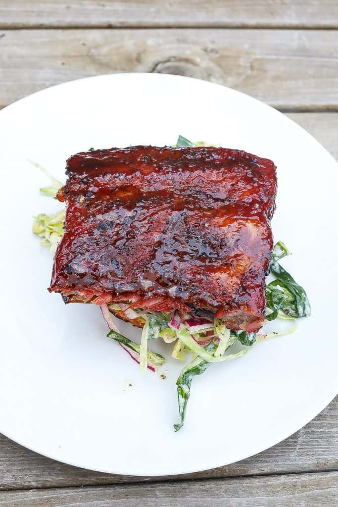 smoked rib sandwich on white plate