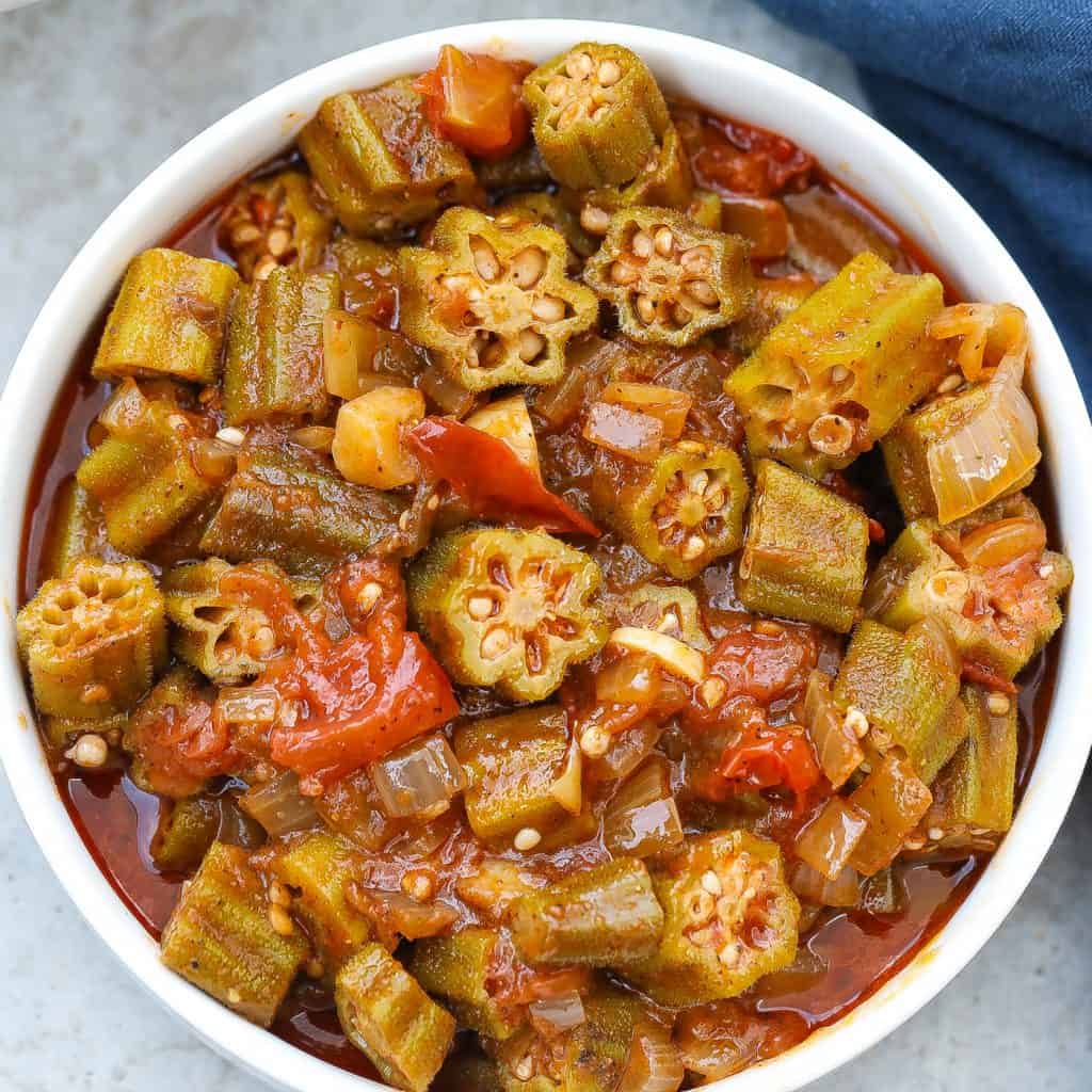 stewed okra and tomatoes in a white bowl