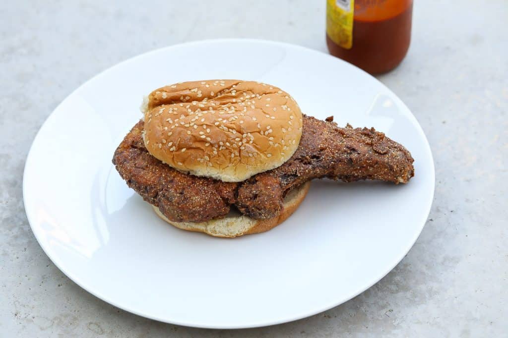 fried pork with bun on white plate