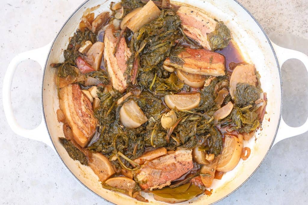 turnip greens with salt bacon and turnip roots in white pot