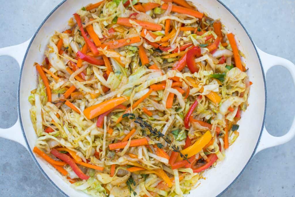 colorful jamaican steamed cabbage in white pan