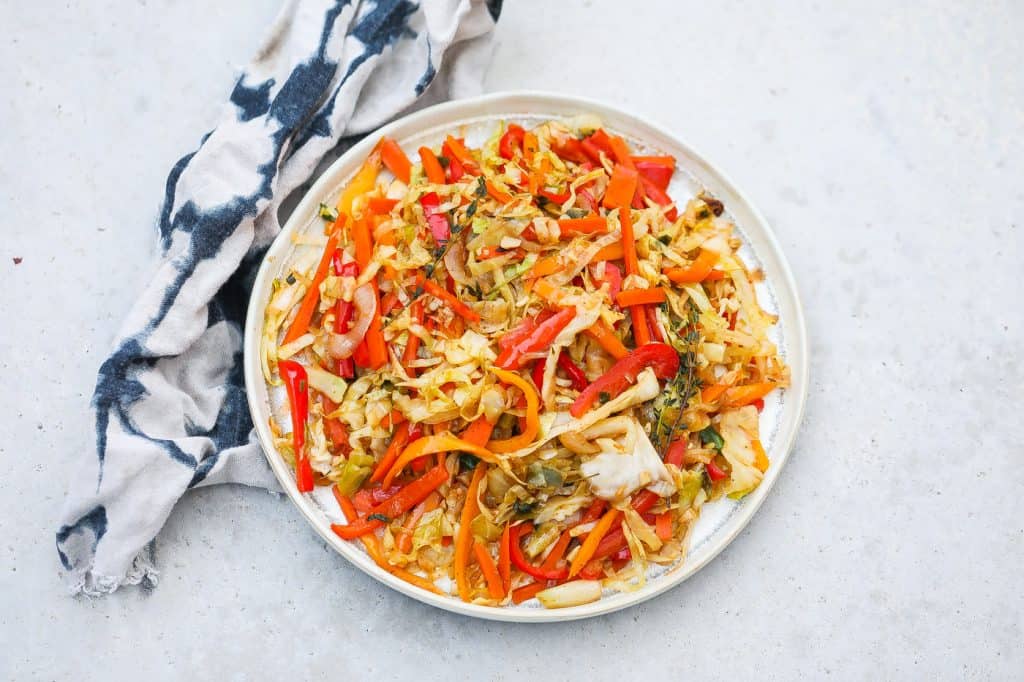 colorful jamaican steamed cabbage in white pan