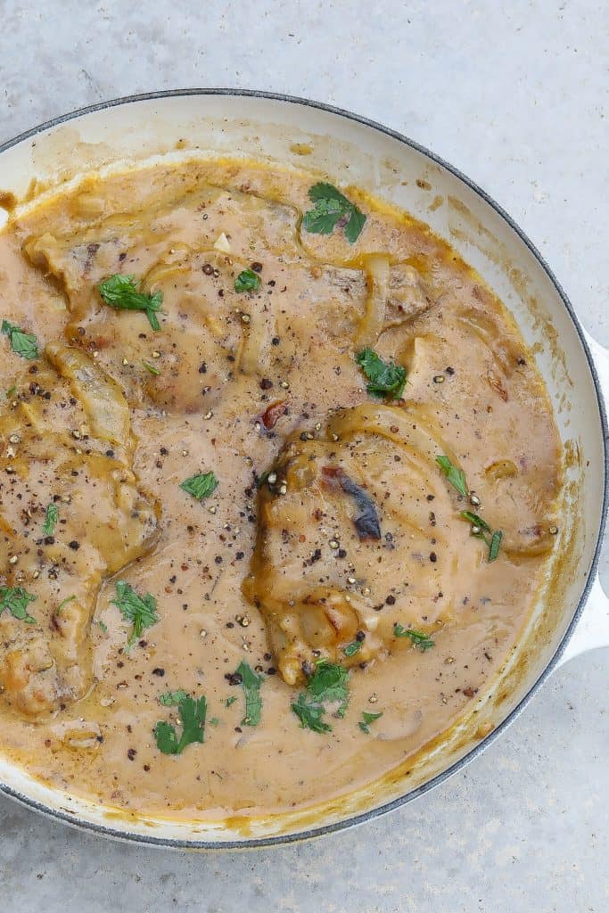 smothered pork chops in white pan