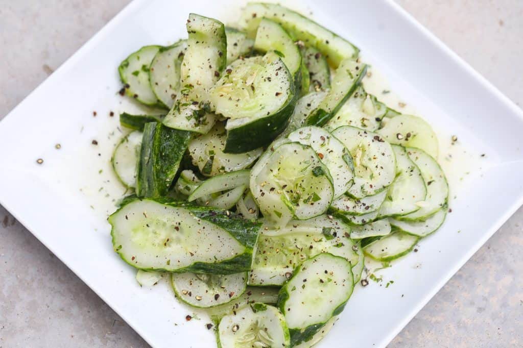 cucumber salad on a white plate