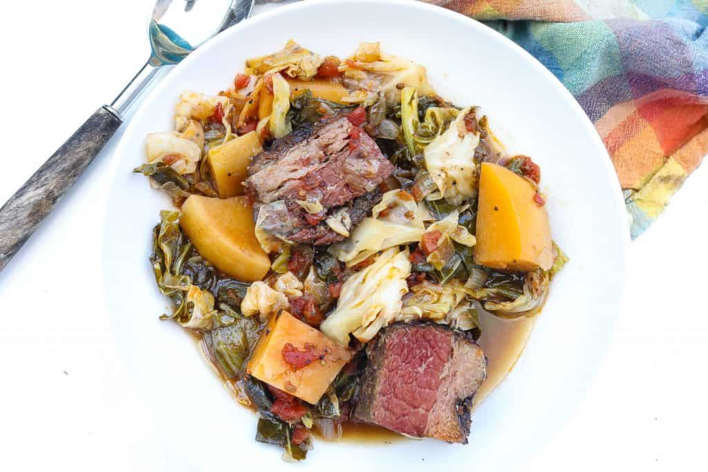 cabbage stew with brisket and rutabagas in white bowl