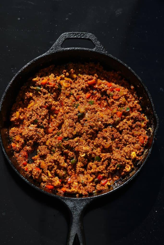 chorizo and eggs in black skillet