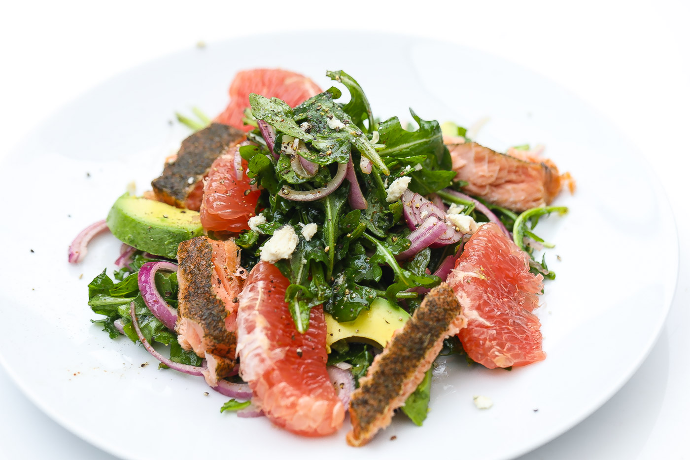 smoked salmon saldad with grapefruit on a white plate