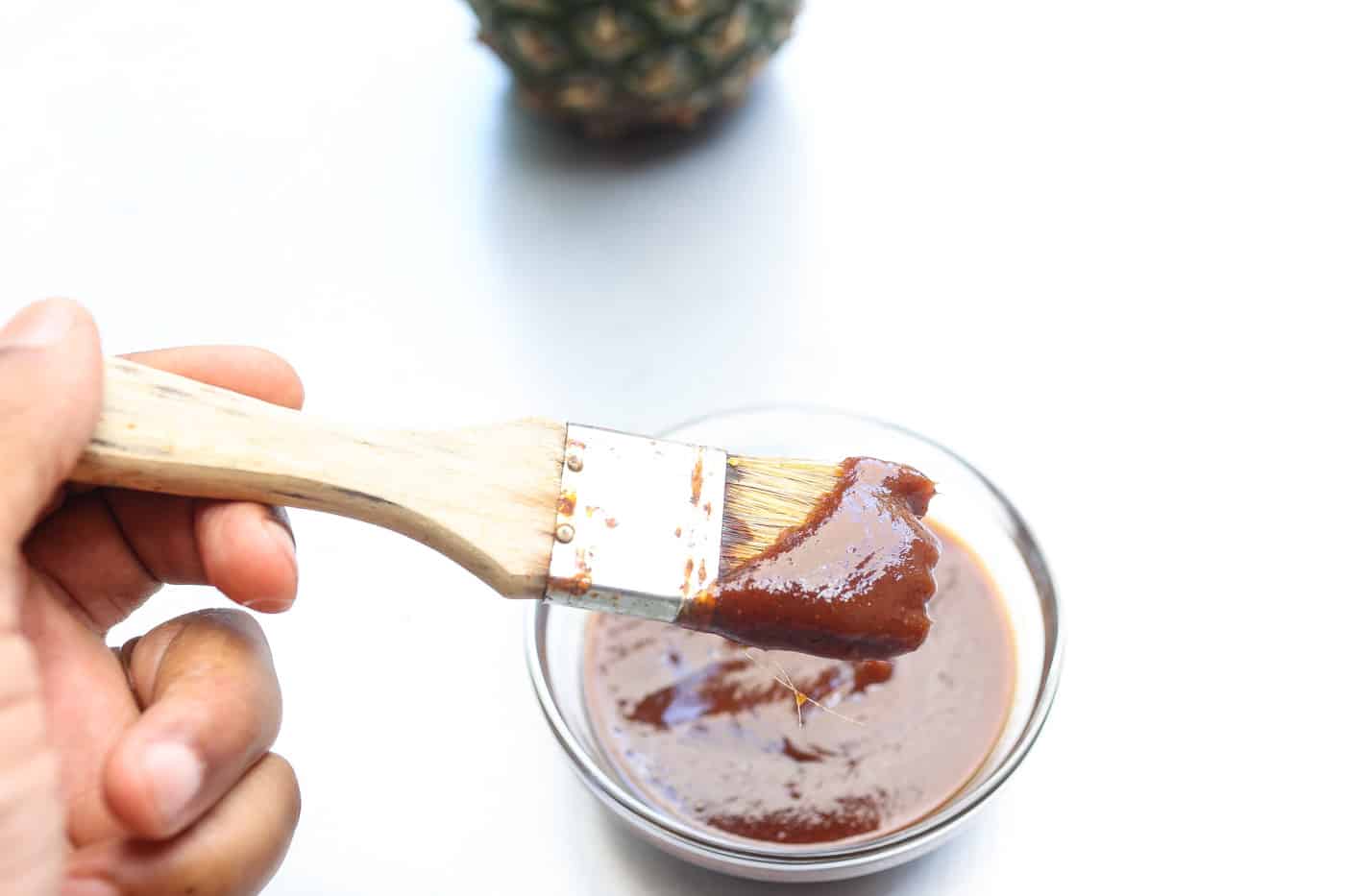 pineapple bbq sauce in a glass bowl with brush