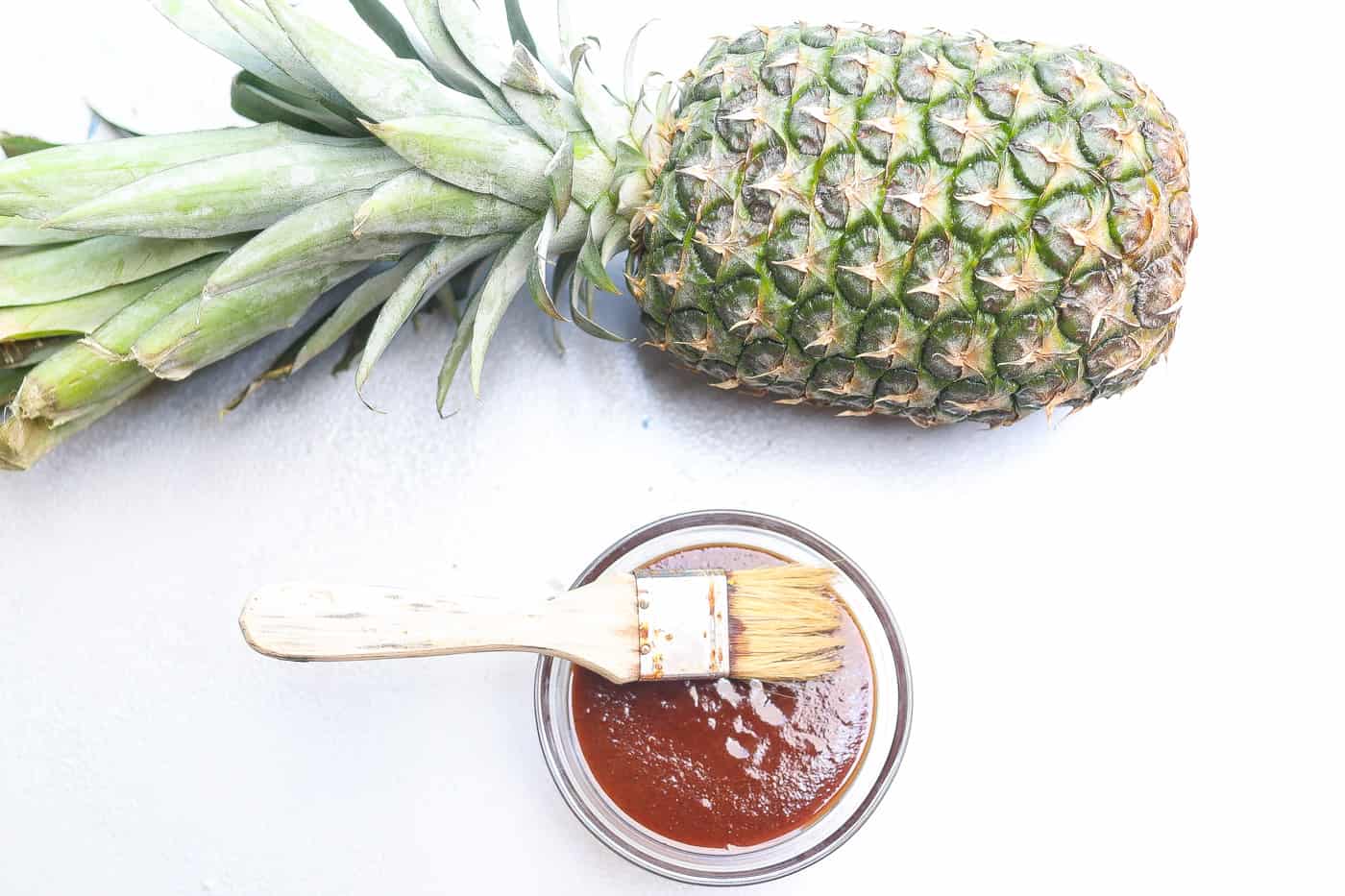 pineapple bbq sauce in a glass bowl with brush