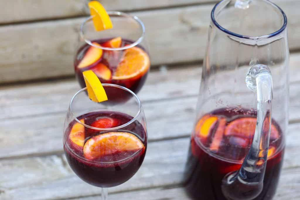 red wine sangria in glasses with orange and peach slices