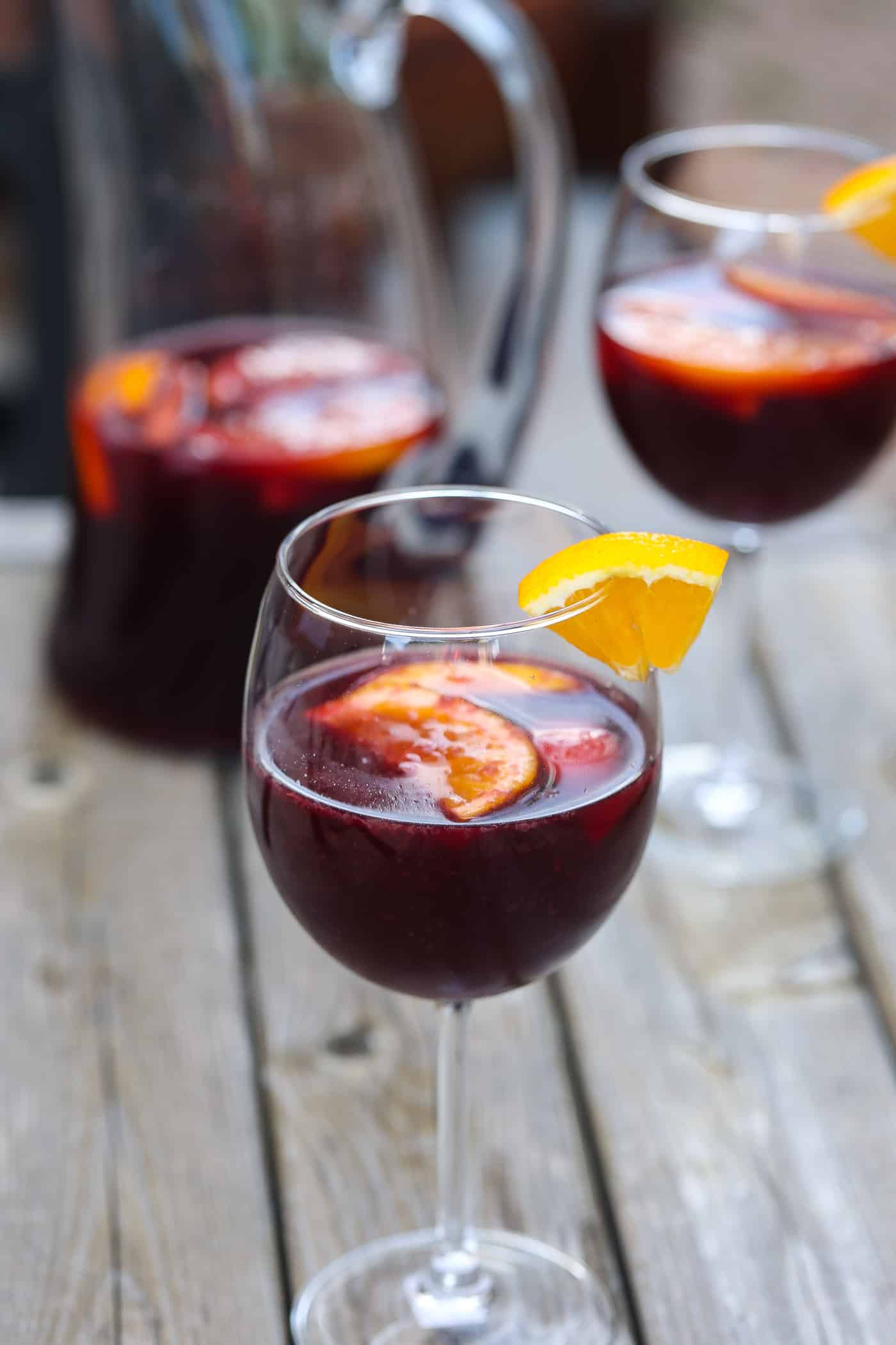 red wine sangria in glasses with orange and peach slices