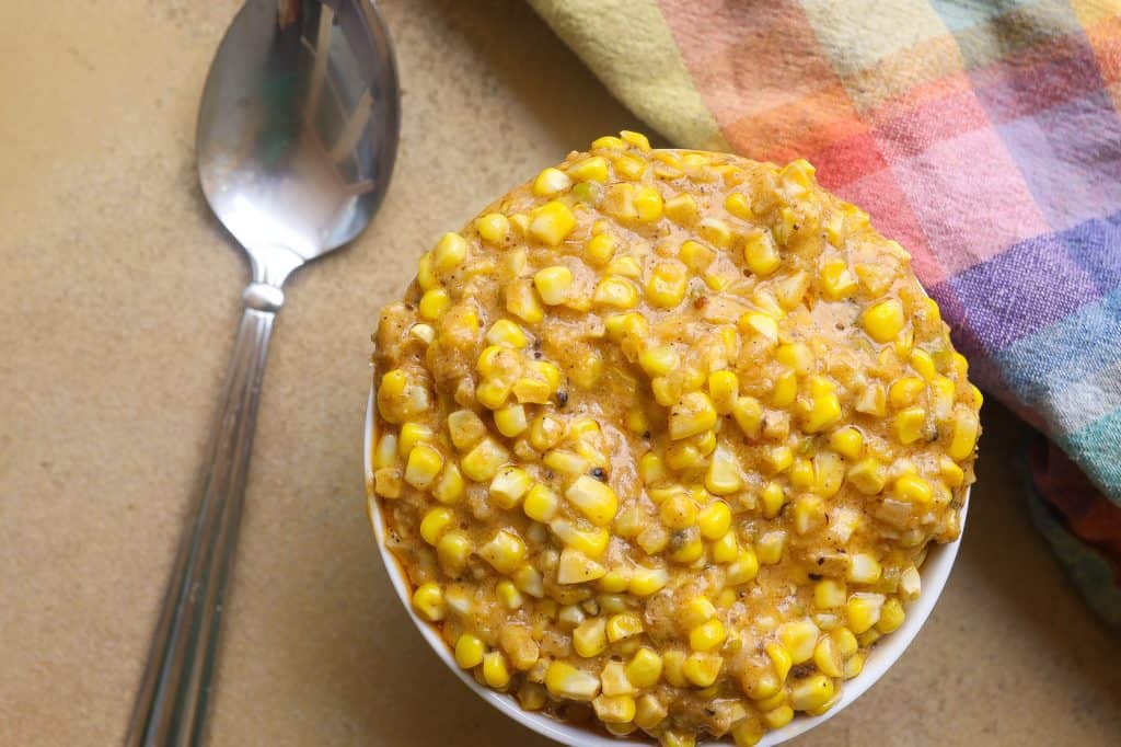 creamed corn kernels in a white bowl