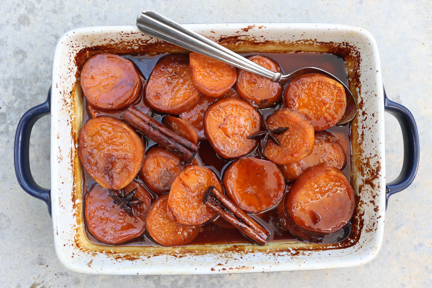 candied yams in a white baking dish