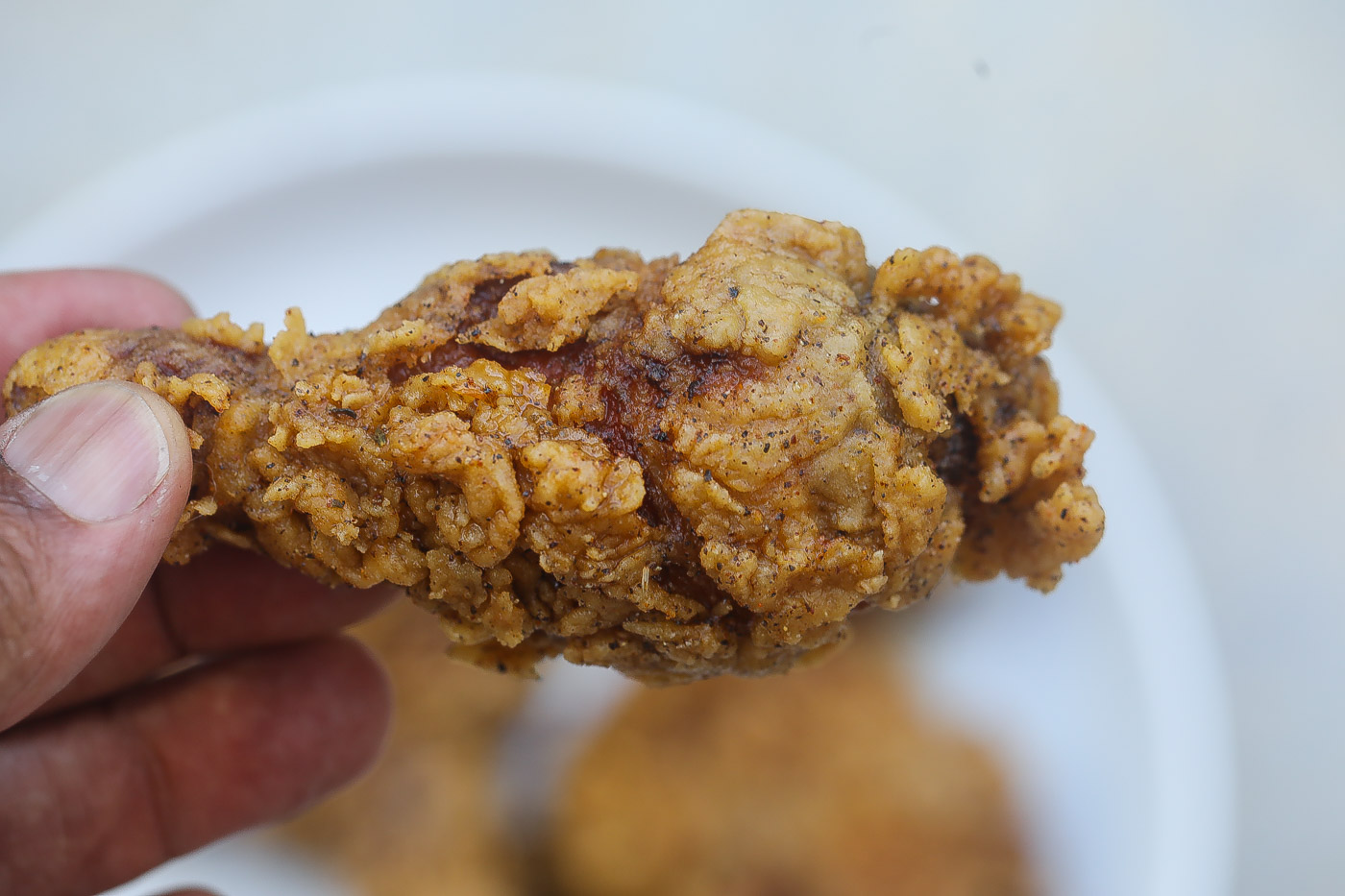 Southern fried chicken pieces on a white plate