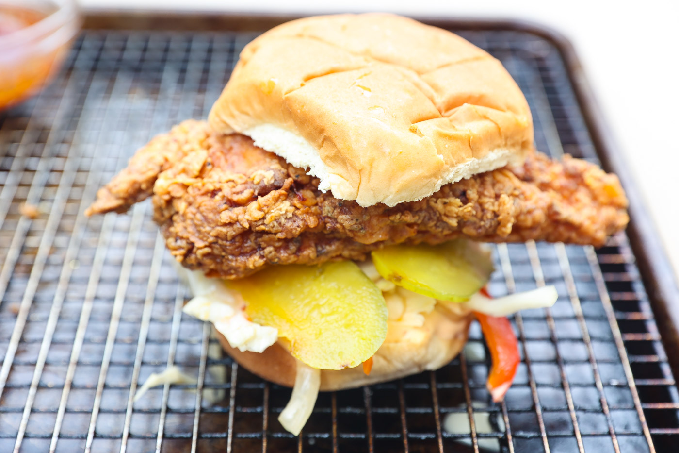 fried chicken sandwich on wire rack lined baking sheet