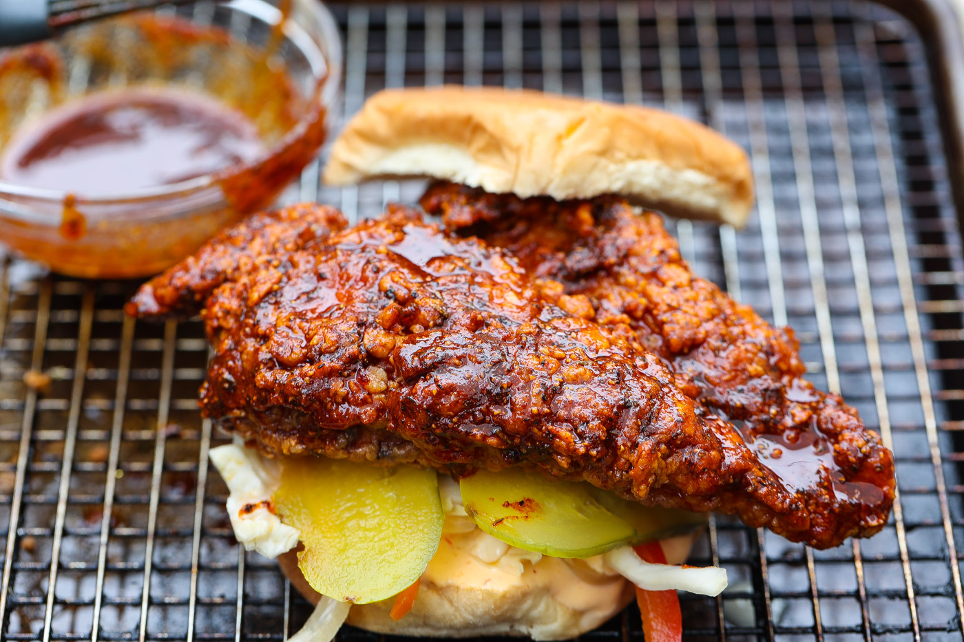 fried chicken sandwich on wire rack lined baking sheet