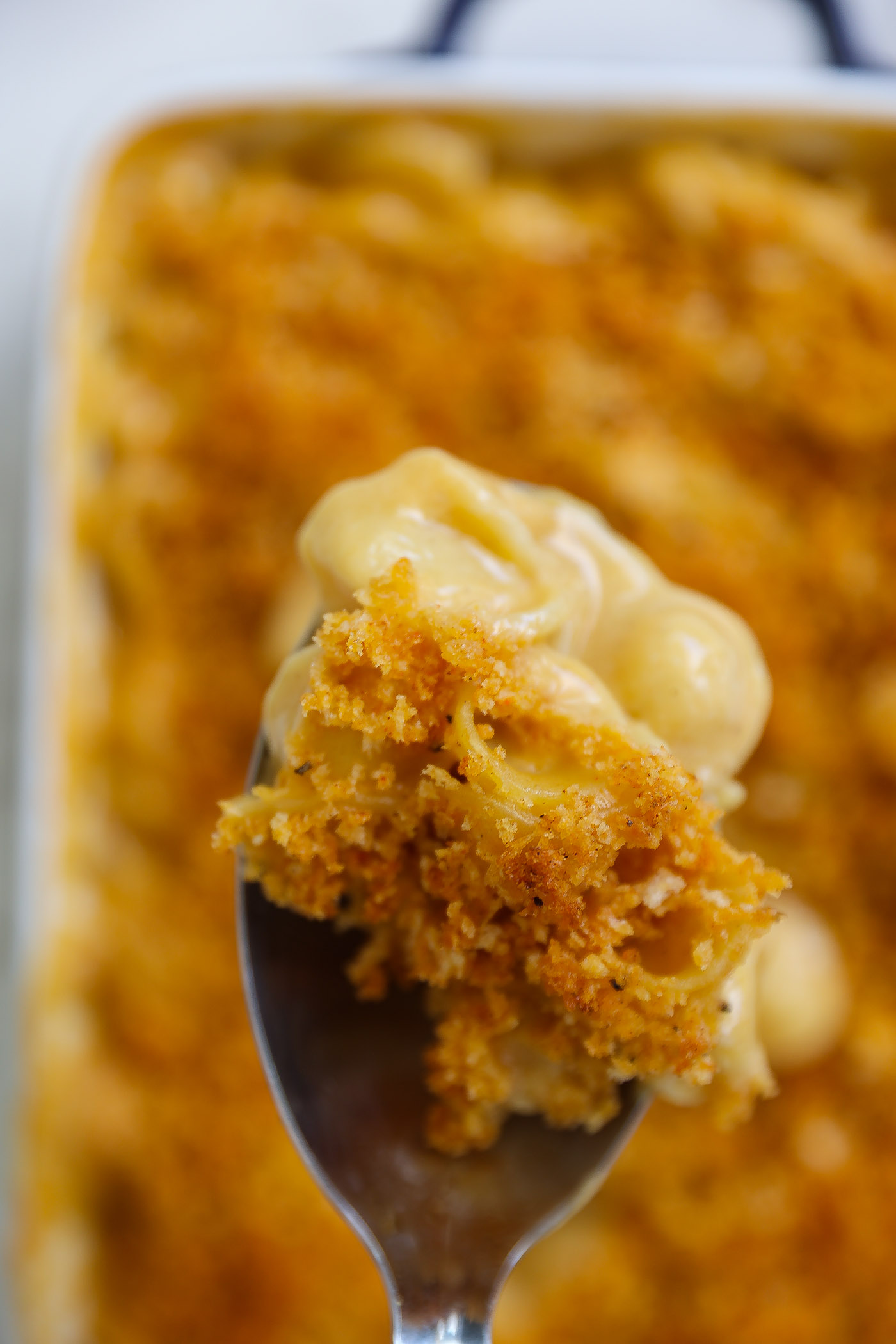 vegan mac and cheese with crunchy topping in a white baking dish