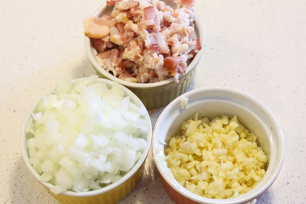 garlic, onions, and hamhocks in ramekins