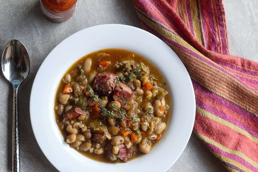 white bean stew with ham hocks in a bowl