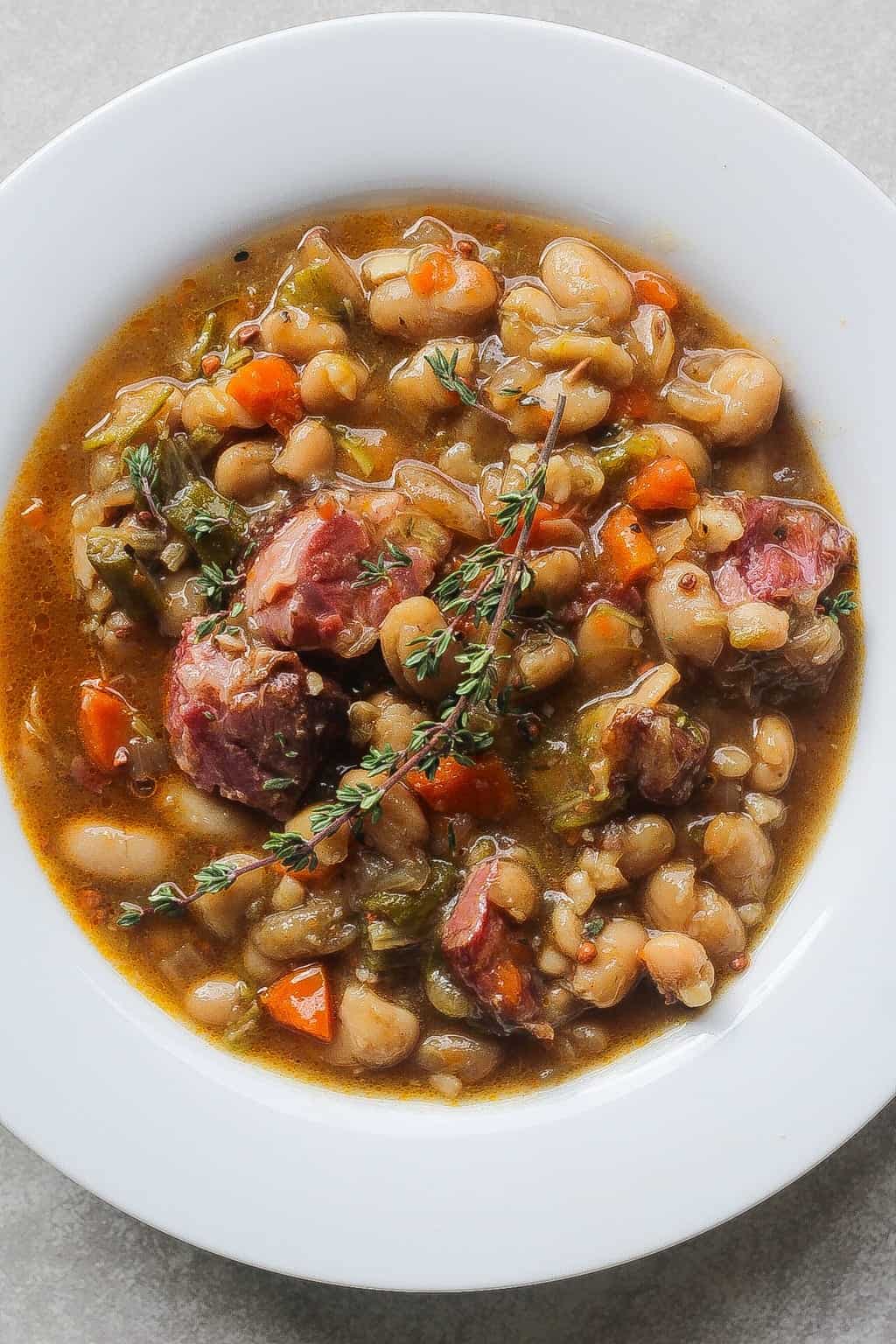 white bean stew with ham hocks in a bowl