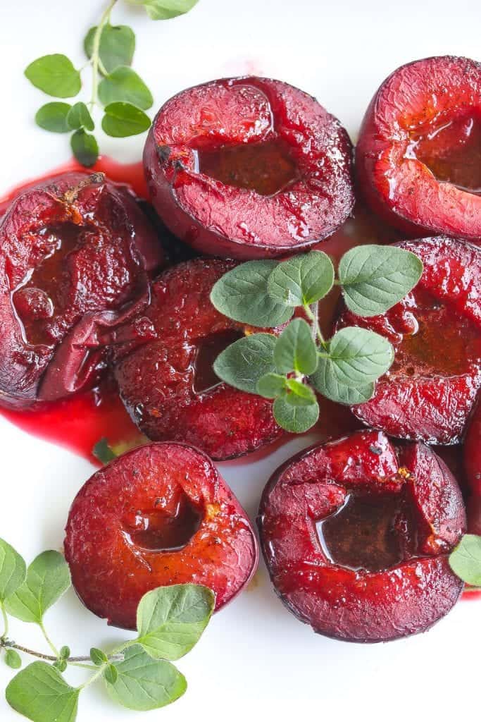 roasted plums on a white plate
